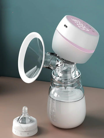 Breast pump with a bottle attachment on a brown surface against a teal background